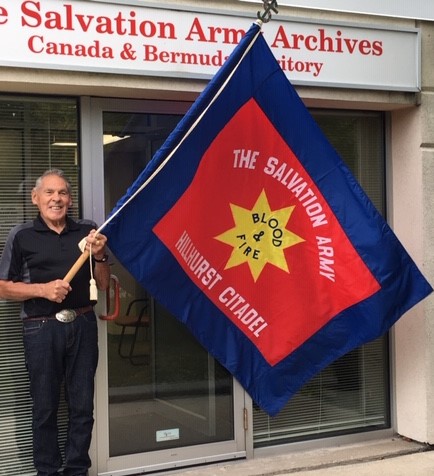 Wayne with Hillhurst flag at archives 3